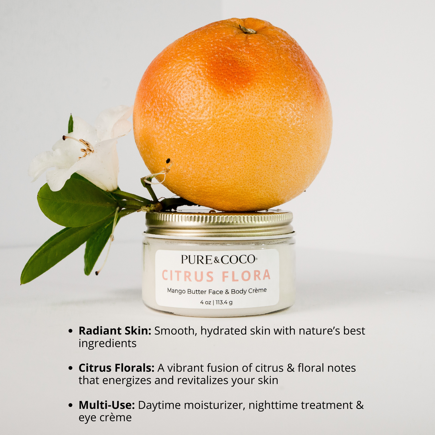 infographic of benefits for the Citrus Flora Mango Butter Face & Body Creme_4 oz_Pure and Coco and a grapefruit and flower sitting on top of the jar of the creme
