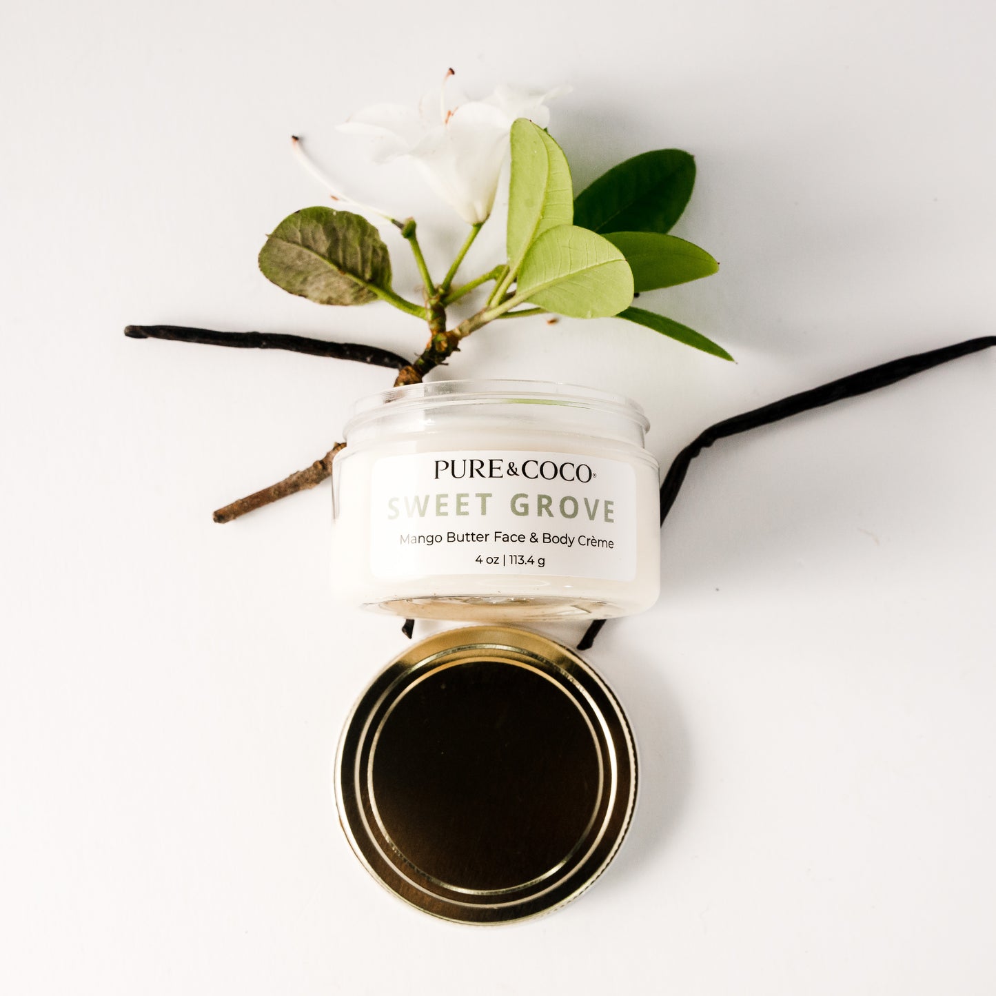 Close-up of Sweet Grove Mango Butter Face & Body Crème texture showing rich, smooth consistency for deep hydration and soft glow.
