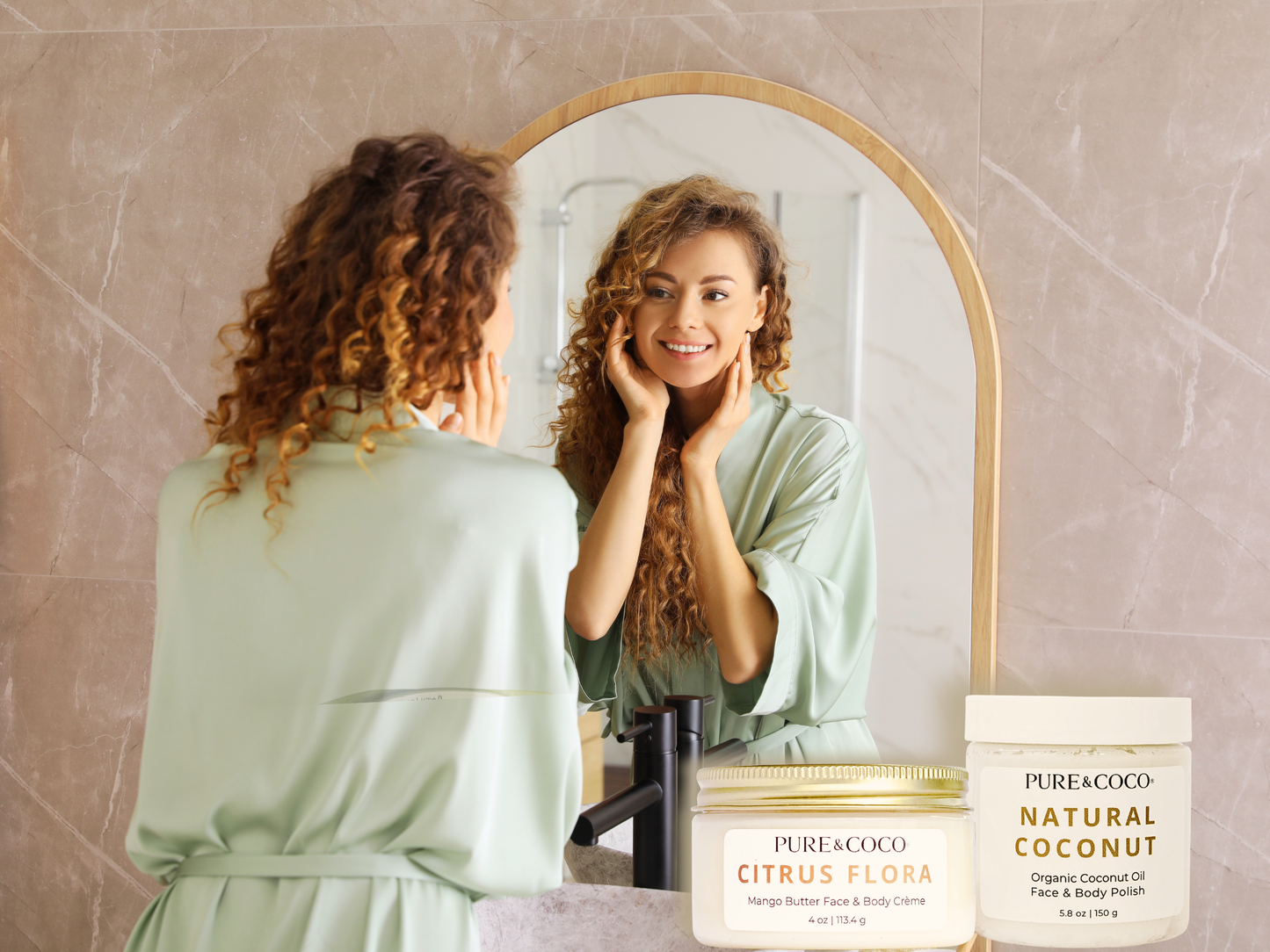 Woman in robe applying Pure & Coco Coconut Polish and Mango Butter Crème in mirror — 2-step daily ritual for hydrated, glowing skin.