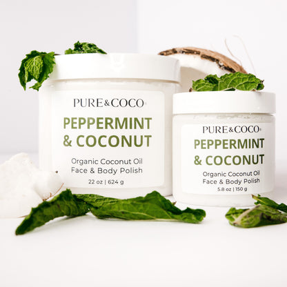 Two jars of Peppermint & Coconut Organic Coconut Oil Face and Body Polish by Pure & Coco with coconut shell and mint leaves on a white background.
