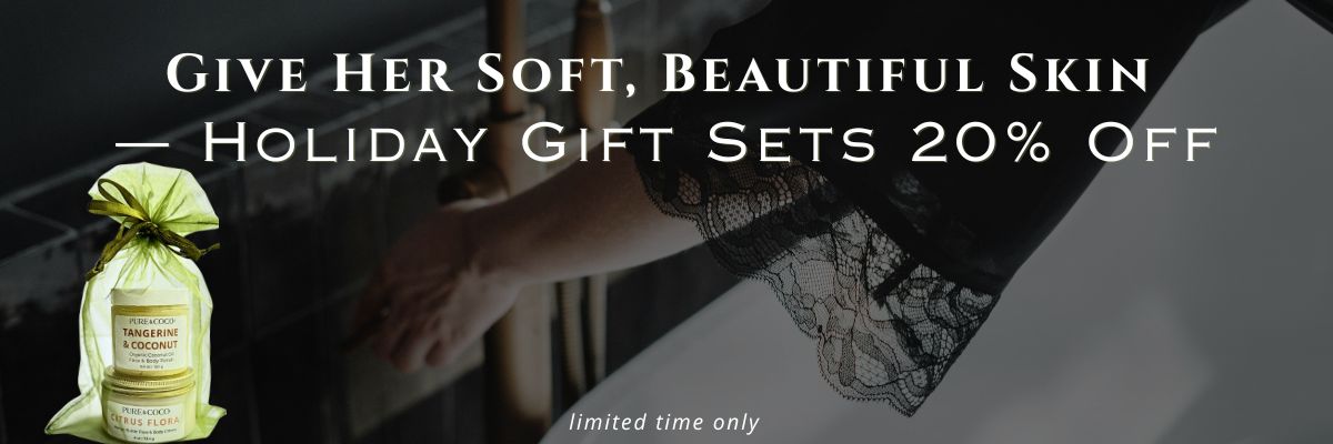 Holiday skincare gift sets from Pure & Coco with Tangerine & Coconut Polish and Citrus Flora Crème in a green organza bag beside a woman’s soft, glowing arm — text reads ‘Give Her Soft, Beautiful Skin — Holiday Gift Sets 20% Off.’